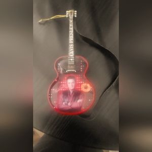 A authentic Elvis mini guitar that plays houndog.